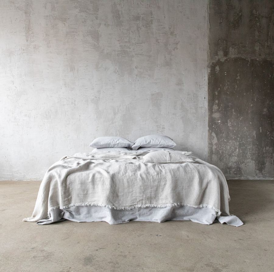 Oatmeal linen blanket styled on a sofa