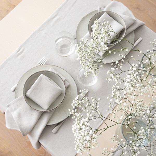 Minimalist Easter table with silver linen runner and napkins