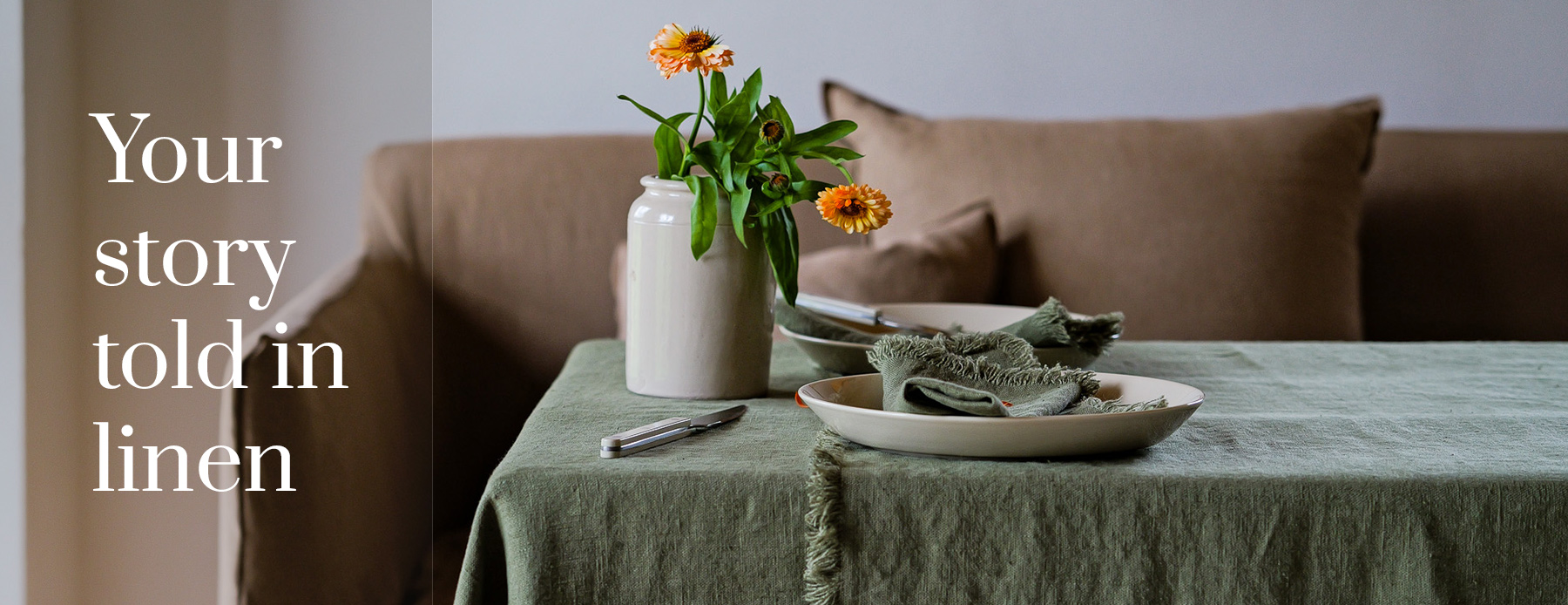 Your story told in linen — green linen tablecloth and napkins with autumn flowers.