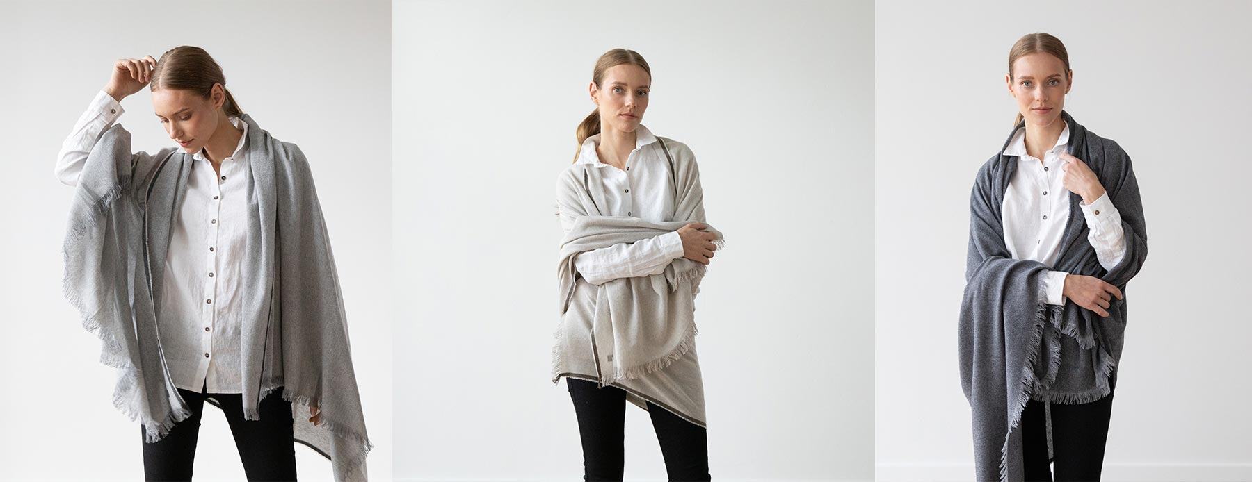 Three views of a woman wearing light grey, beige and dark grey merino wool shawls.