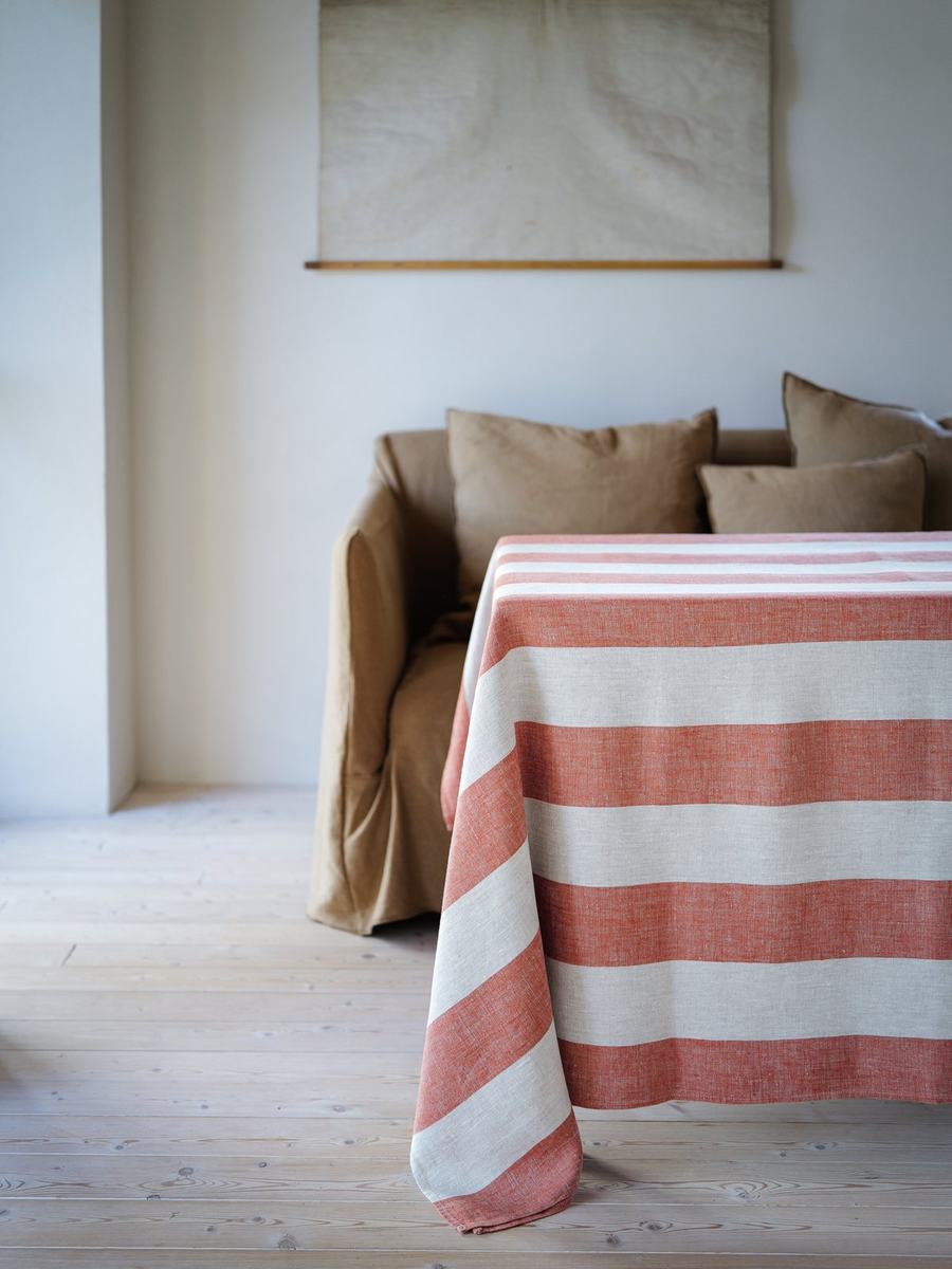 Venice Brick striped linen tablecloth draped over a dining table