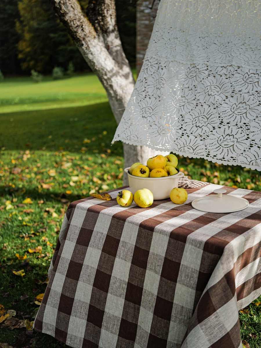 Choco Grand Check tablecloth draped over an orchard table