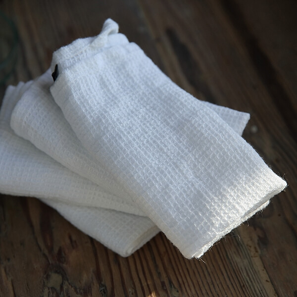 Neatly folded guest bathroom towels in several useful sizes
