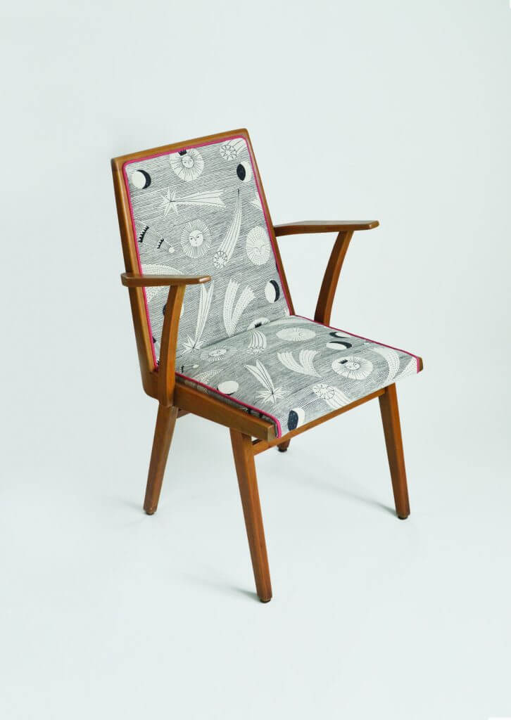 Wooden chair upholstered in dark celestial-patterned fabric