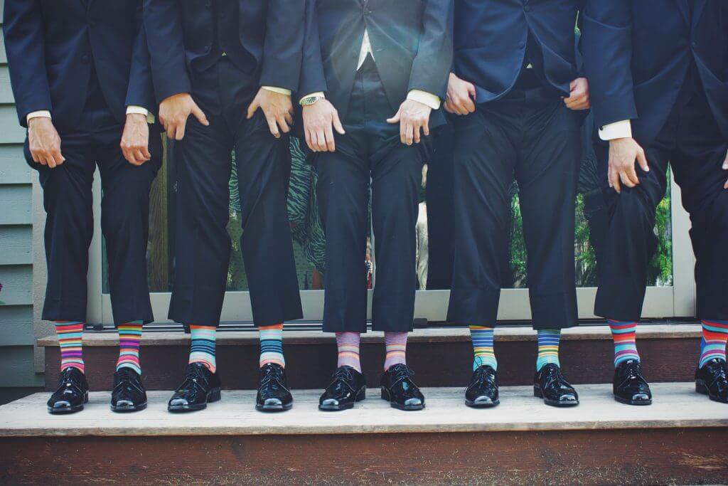 Colourful socks worn with dark suits