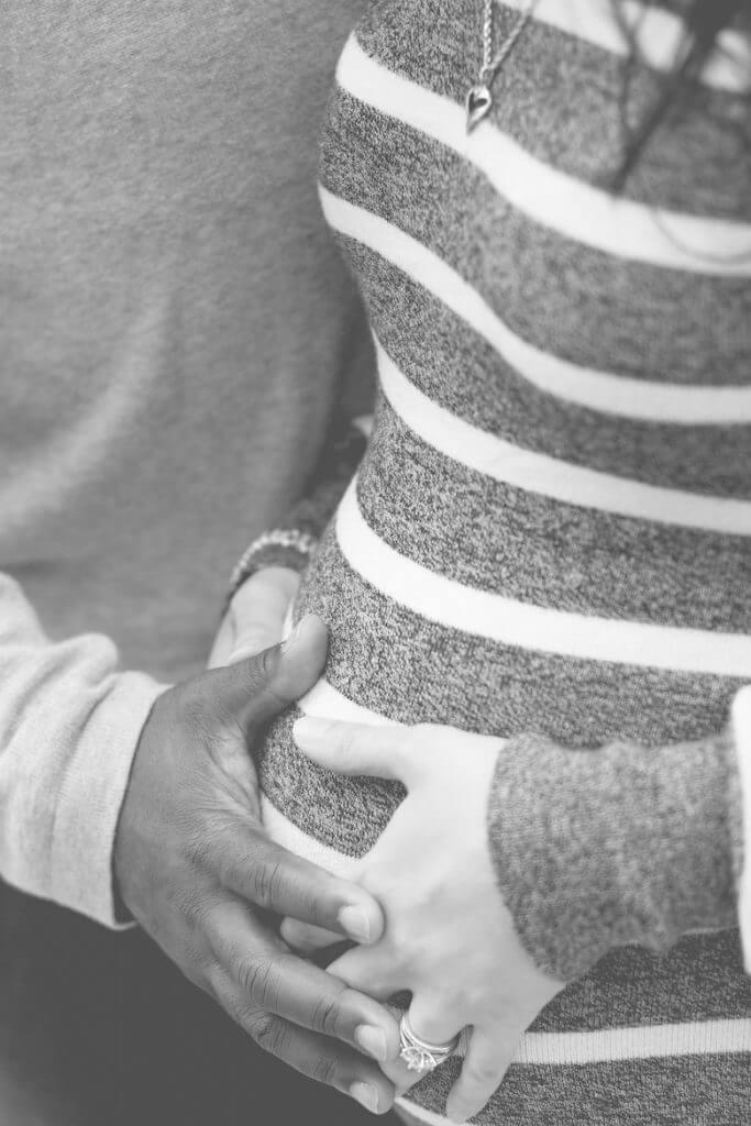 Pregnant woman cradling her belly