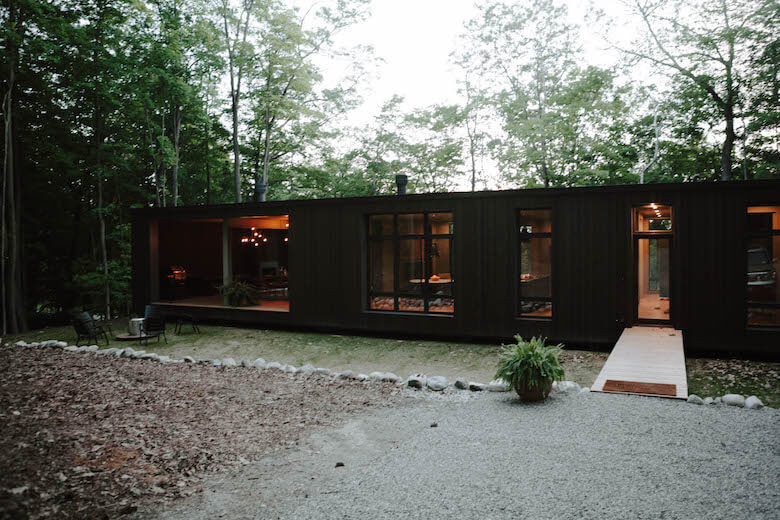 Hygge Supply Birch Le collaboration house illuminated among trees at dusk