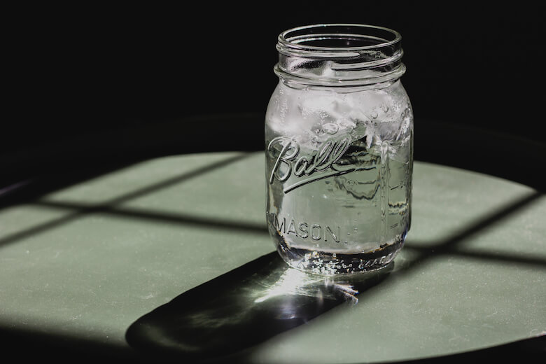 Glass of water beside a bed on a warm summer night