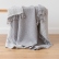 Grey Marcus merino wool throw draped over a chair
