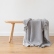 Marcus grey merino wool throw displayed with fringed edges